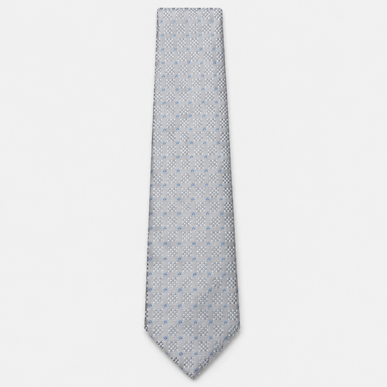 The Terni Tie – silver grey and light blue geometric silk tie on a light grey background