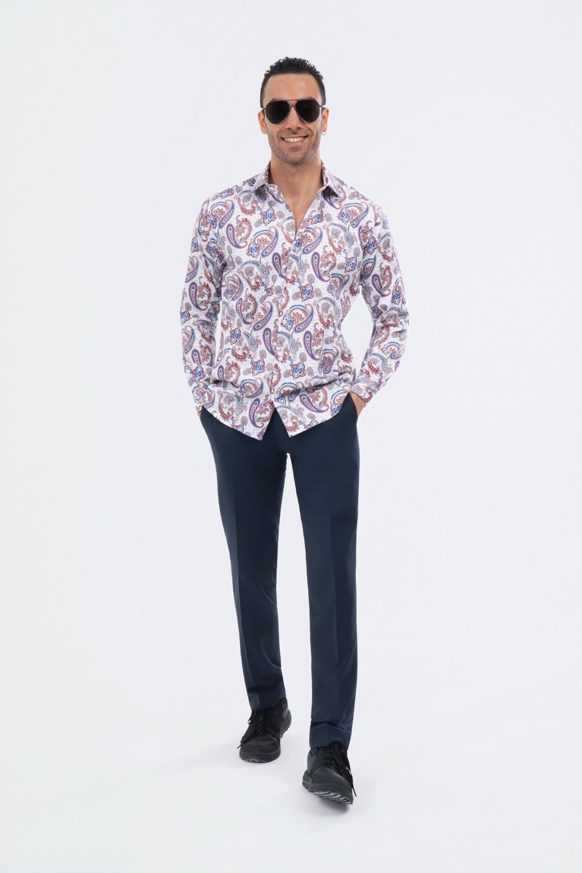 Male model wearing a white and lavender paisley shirt with black trousers.