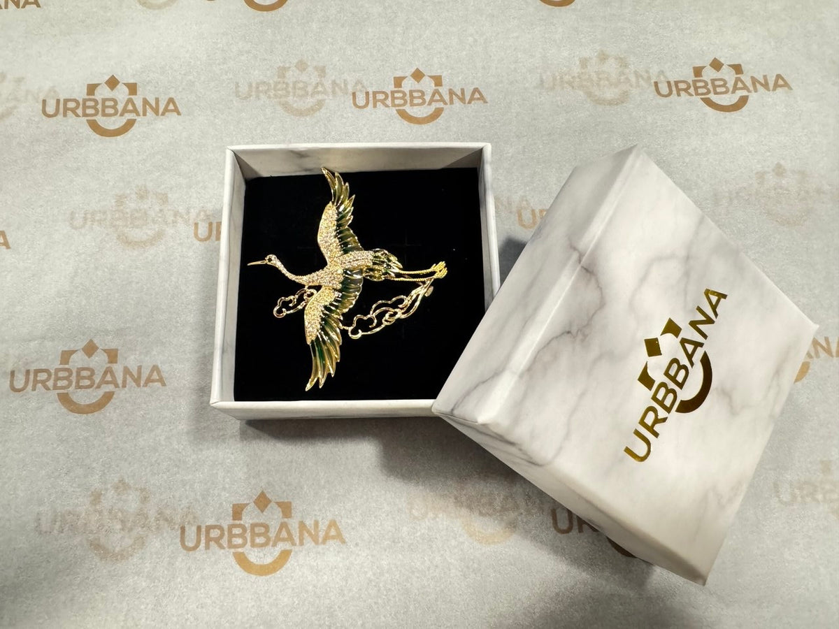 Elegant gold-toned lapel pin of a flying crane