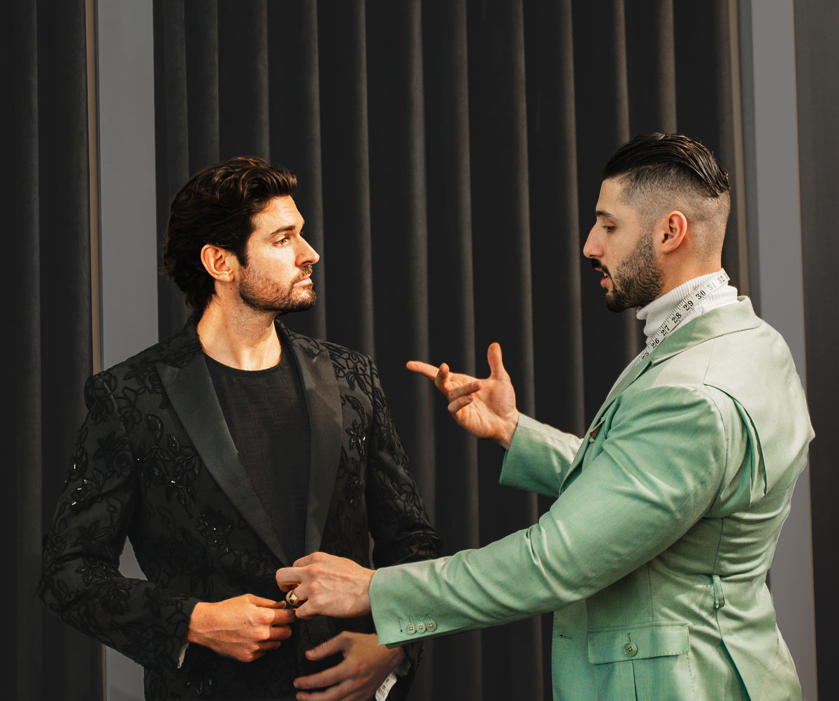 An URBBANA stylist discussing the fit of a jacket with a client