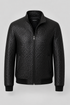 A black textured zip-up jacket with a woven basketweave pattern, featuring a stand collar, front zipper, and ribbed cuffs and hem, shown against a light gray background.