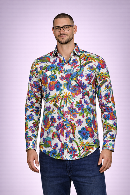 Man wearing a colorful floral shirt against a light purple background