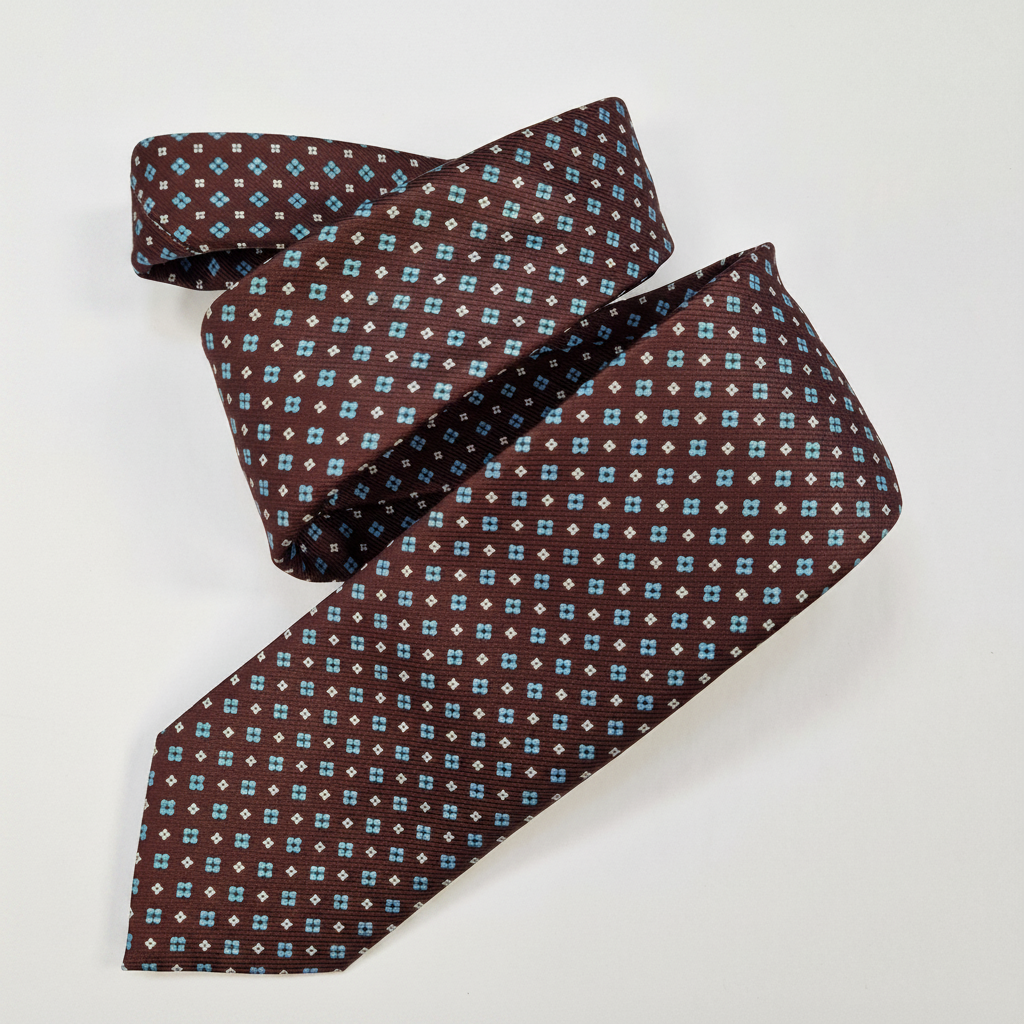 The Como Tie - silk tie laid flat on light grey background