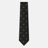 The Aosta Tie – black and gold fleur-de-lis silk tie on a light grey background