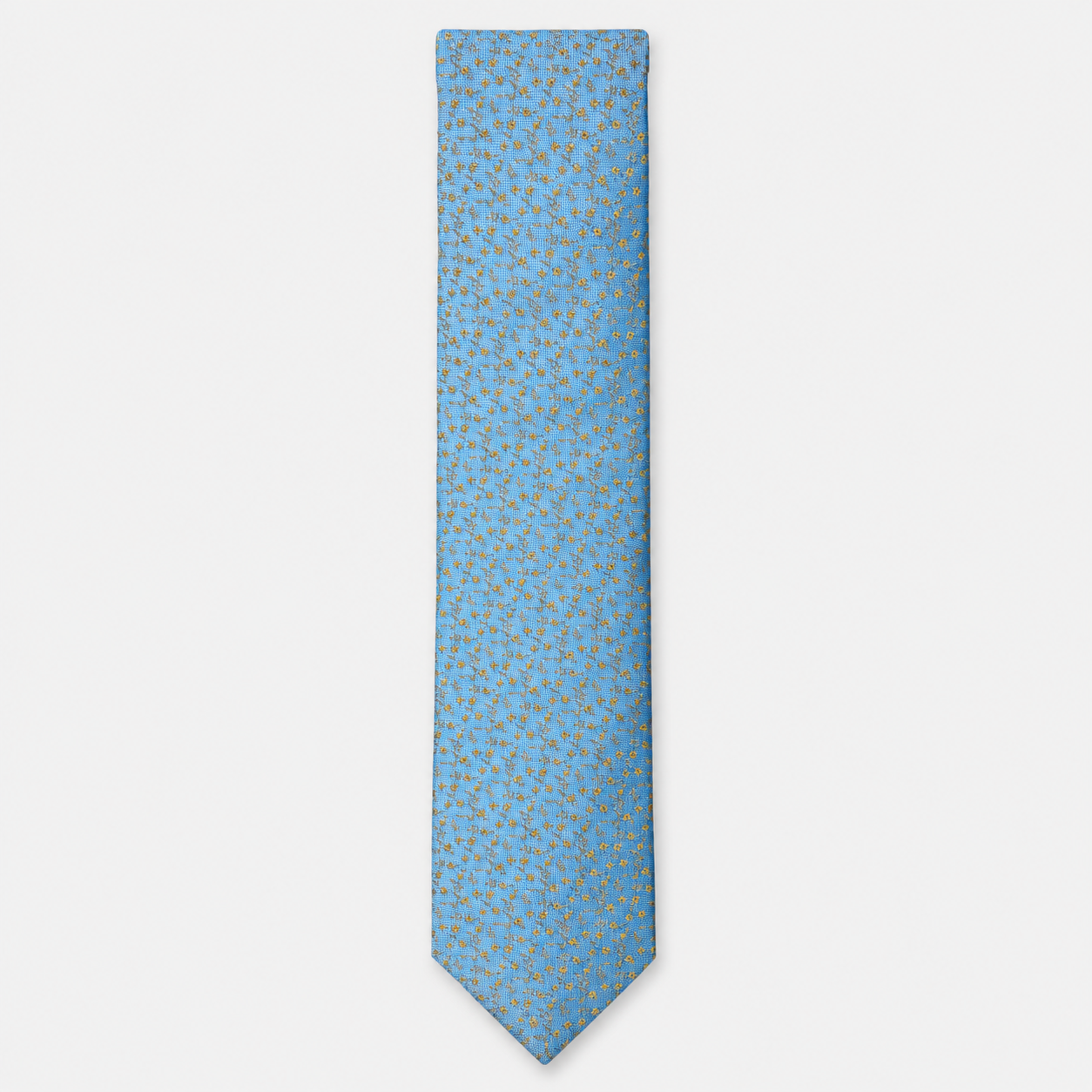 The Brindisi Tie – sky blue and gold micro ornamental silk tie on a light grey background