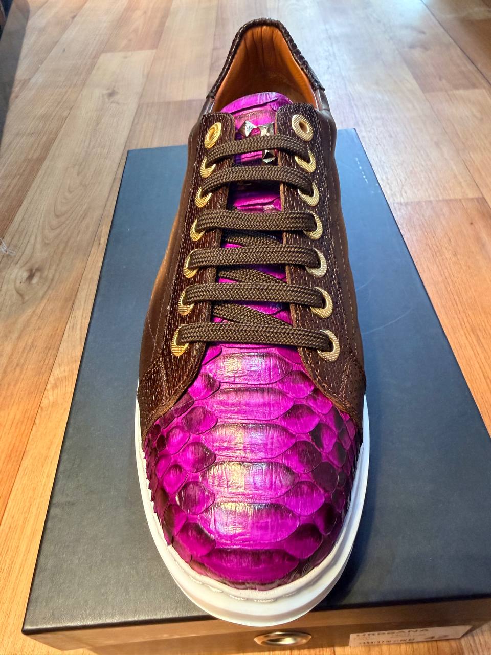 Brown and fuchsia exotic leather low-top sneaker with a white sole.