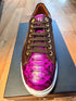 Brown and fuchsia exotic leather low-top sneaker with a white sole.