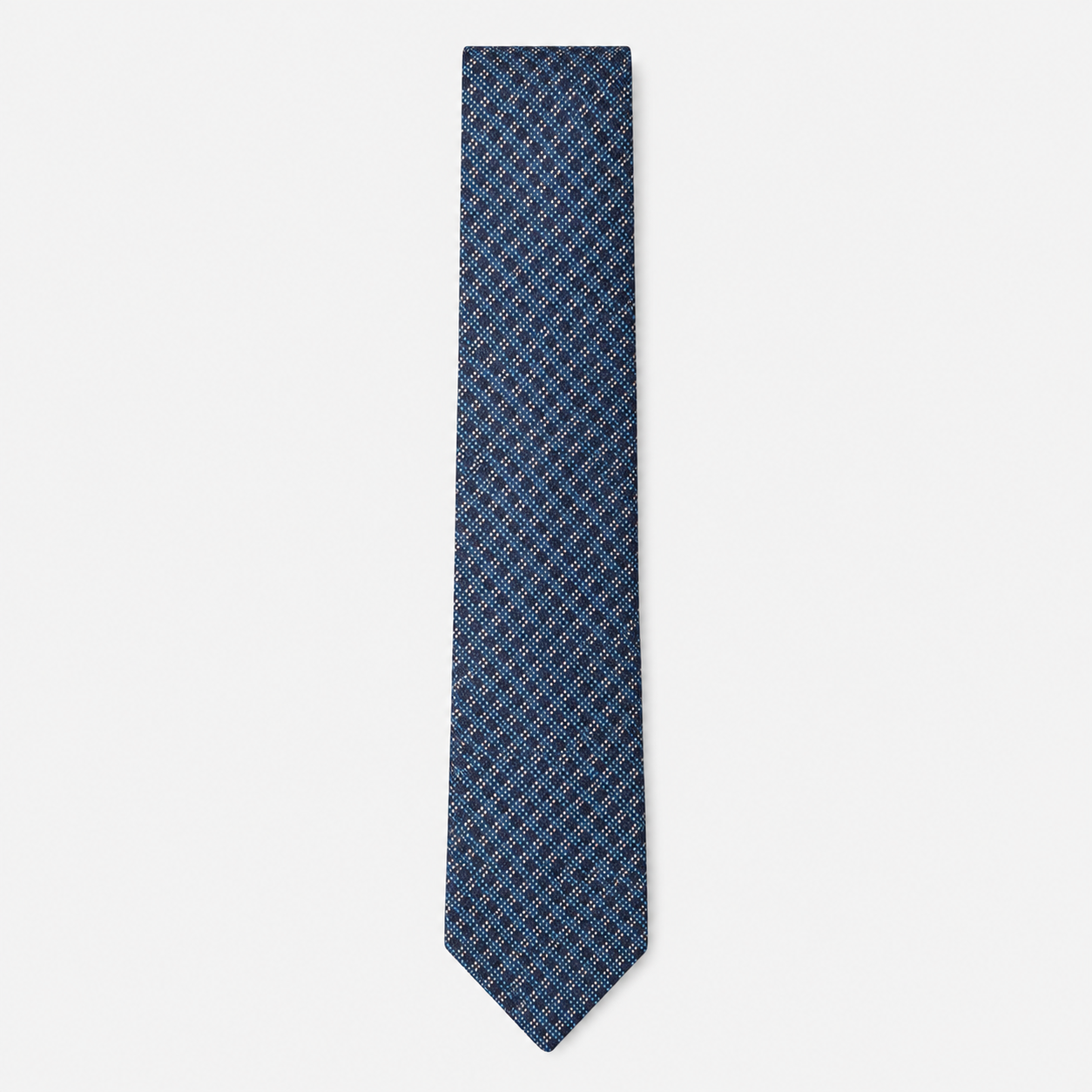 The Cagliari Tie – blue, navy and rust micro diamond silk tie on a light grey background