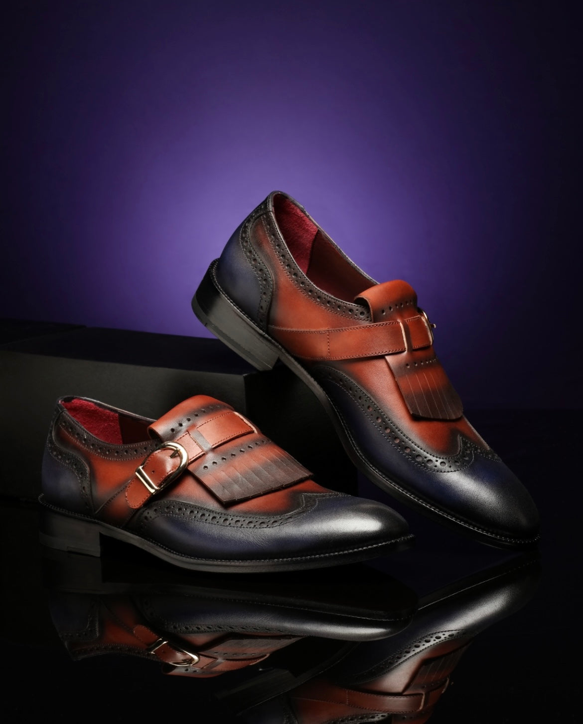 URBBANA cognac and dark-blue fringed brogue loafers.