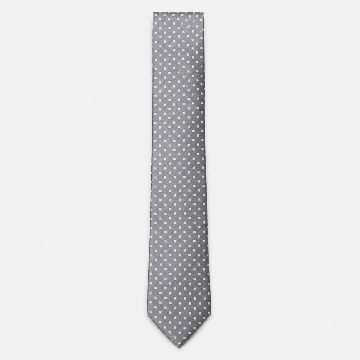 The Cosenza Tie – silver grey and white polka dot silk tie on a light grey background
