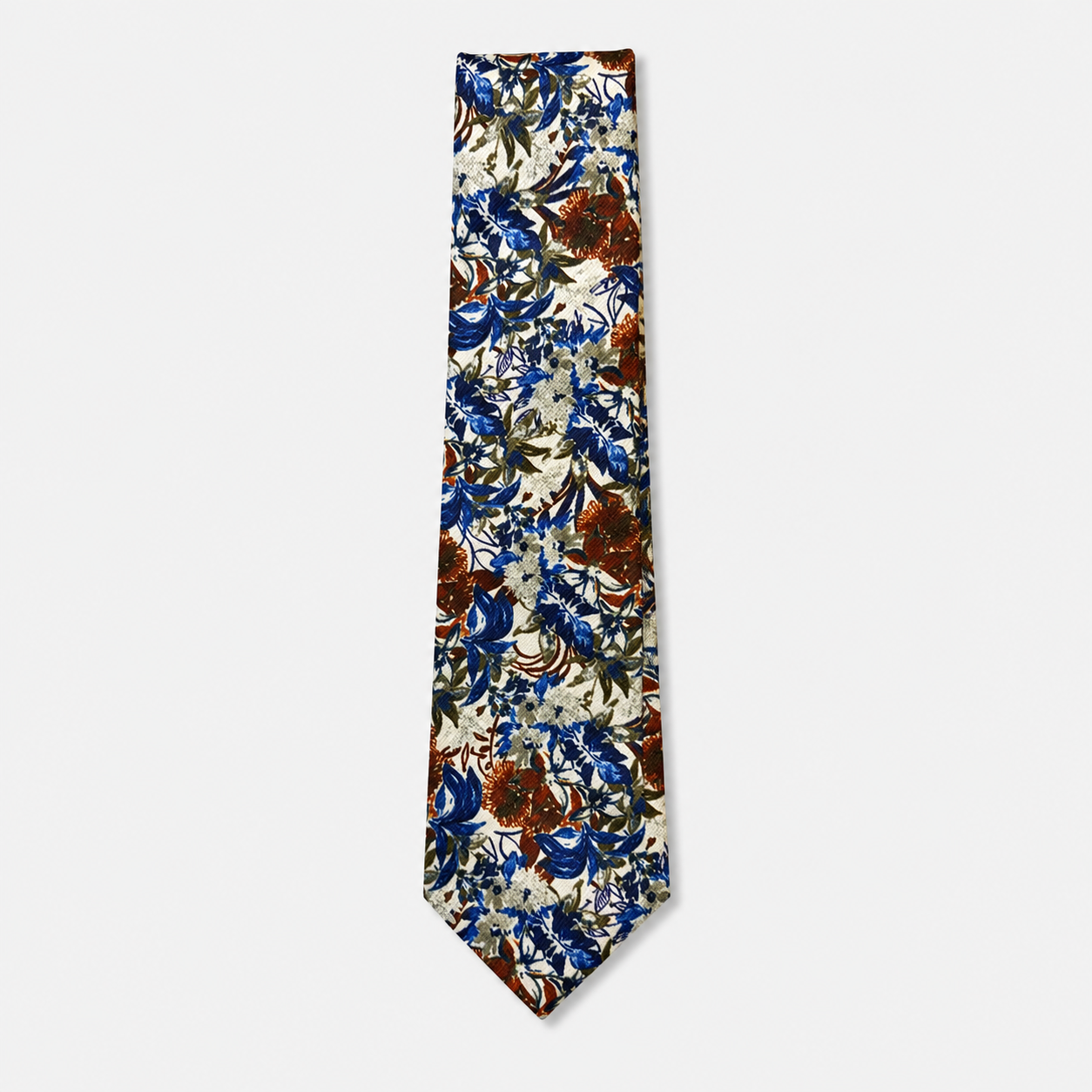 The Matera Tie, an ivory silk tie with navy blue, rust and olive botanical motifs on a light grey background.