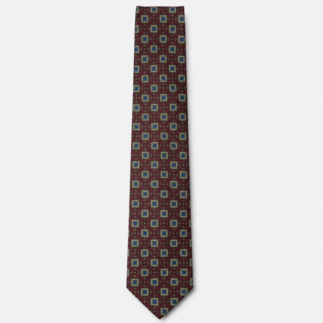 The Rimini Tie – brown, turquoise and red geometric square silk tie on a light grey background