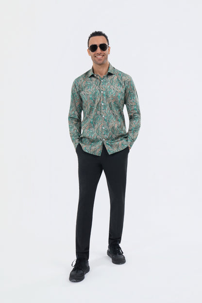 Male model wearing a sage green paisley shirt with black trousers.