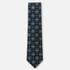 The Savona Tie, a navy silk tie with blue, turquoise and gold rosette medallions on a light grey background.