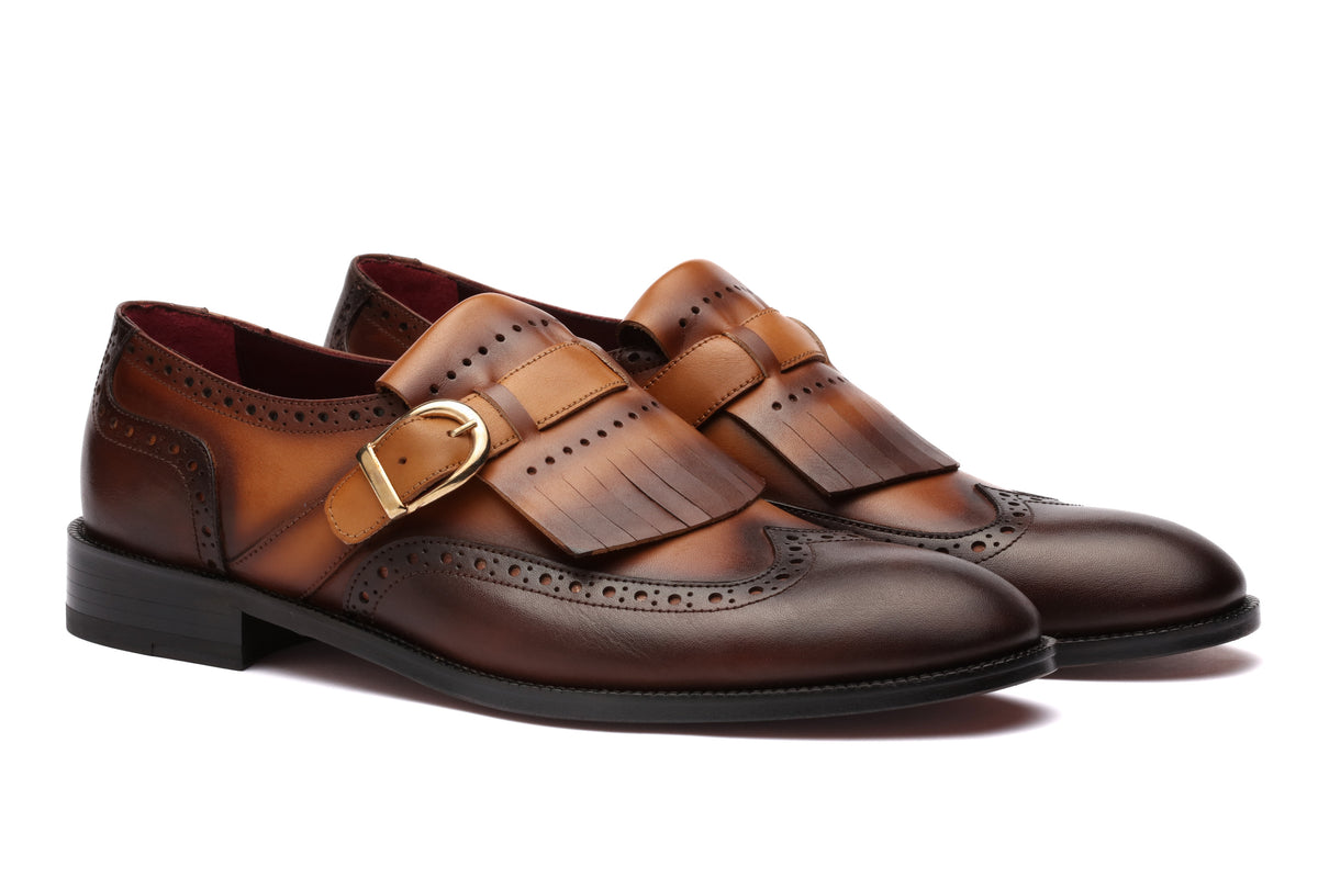 URBBANA tan and brown fringed brogue loafers.